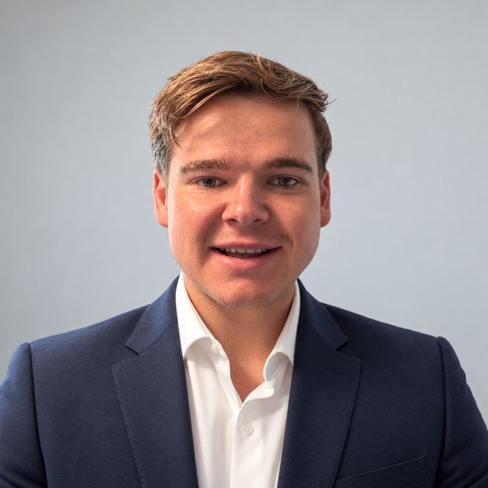 Alex Nevills wearing a navy suit
